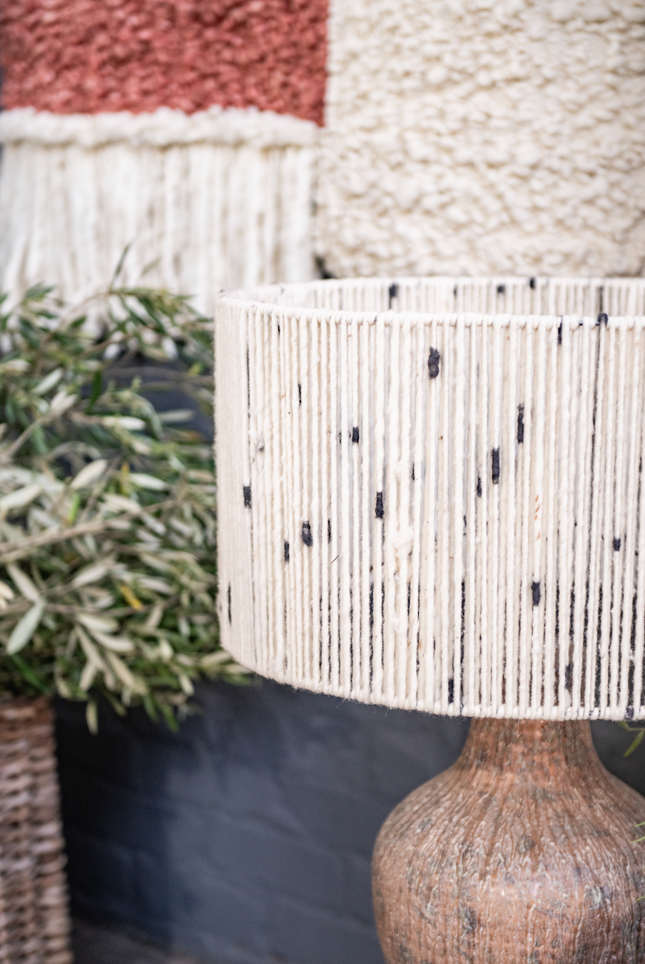 Close-up of a textured lamp with a natural base and blurred background